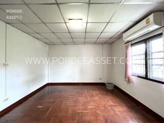 Empty room with wooden floor and large window