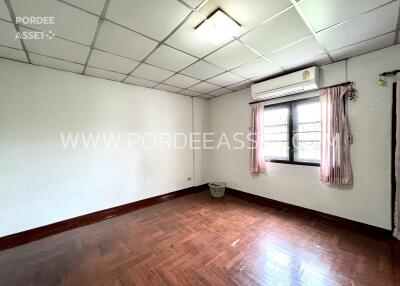 unfurnished bedroom with window and air conditioner