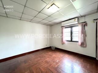 unfurnished bedroom with window and air conditioner