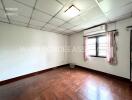 unfurnished bedroom with window and air conditioner