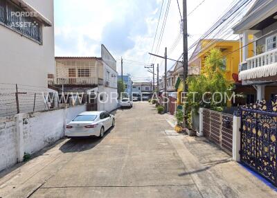 Street view of neighborhood with houses and parked cars