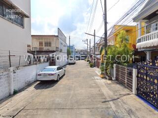 Street view of neighborhood with houses and parked cars