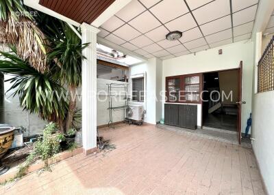 Covered outdoor patio area with plants