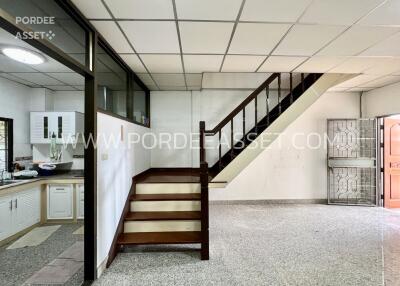 Living area with staircase and adjacent kitchen