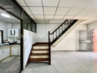 Living area with staircase and adjacent kitchen