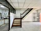 Living area with staircase and adjacent kitchen