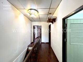 Hallway with wooden flooring and ceiling lights