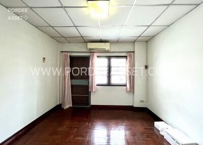 A vacant bedroom with a window and air conditioning unit