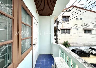 Balcony view with neighboring buildings and electrical wires