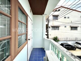 Balcony view with neighboring buildings and electrical wires