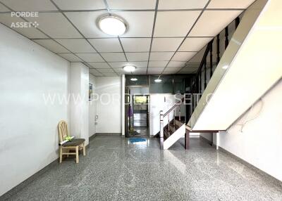 Spacious main living area with staircase to upper floor