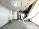 Spacious main living area with staircase to upper floor