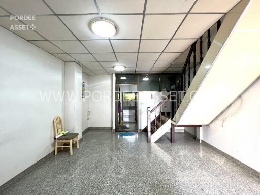 Spacious main living area with staircase to upper floor