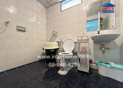 Photo of a bathroom with toilet, sink, and other amenities