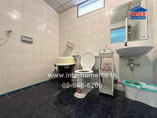 Photo of a bathroom with toilet, sink, and other amenities