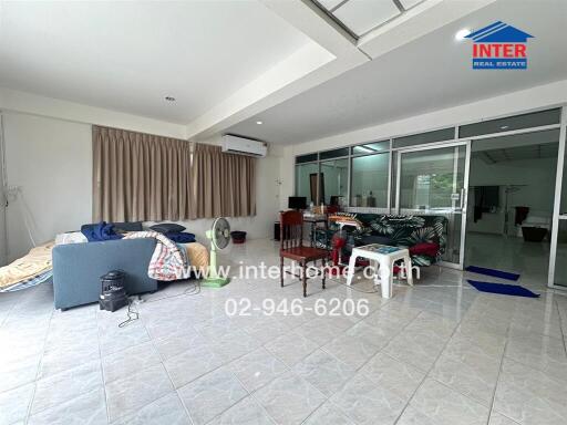 Spacious living area with tiled floor and large windows