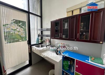 Modern kitchen with sink, cabinets, and patio door