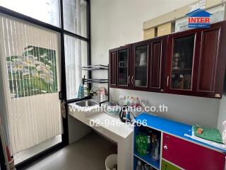 Modern kitchen with sink, cabinets, and patio door