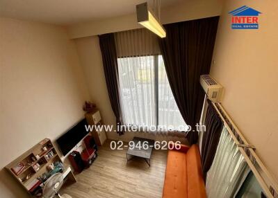 Living room with modern furniture, large window, and air conditioning