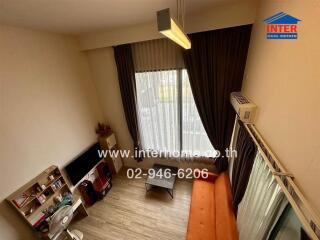 Living room with modern furniture, large window, and air conditioning