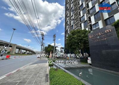 External view of condominium building with main entrance and sign