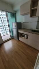 Modern kitchen with wooden flooring and appliances