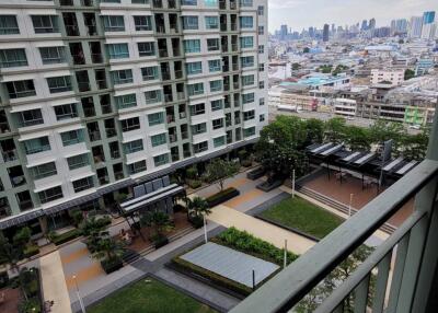 View from balcony overlooking building and cityscape