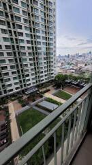 View from balcony overlooking building and cityscape