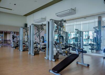 Fully equipped gym with exercise machines and mirrored walls