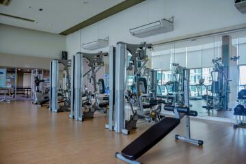 Fully equipped gym with exercise machines and mirrored walls