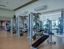 Fully equipped gym with exercise machines and mirrored walls