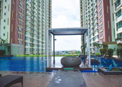 Outdoor pool area between two high-rise residential buildings