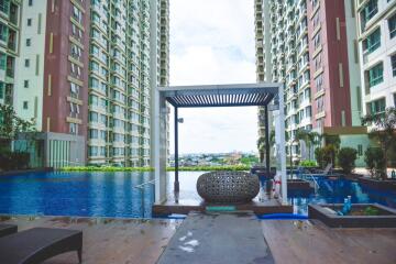 Outdoor pool area between two high-rise residential buildings