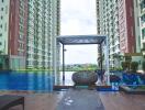 Outdoor pool area between two high-rise residential buildings