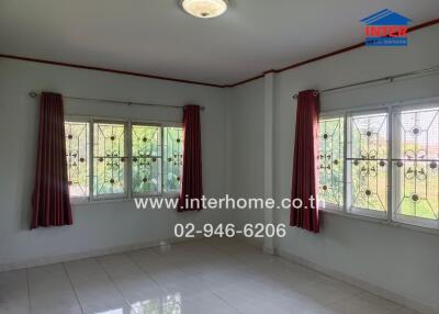 Bedroom with tiled floor, windows, and curtains