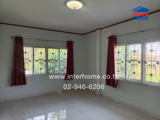 Bedroom with tiled floor, windows, and curtains