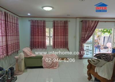 Cozy living room with large windows and pink curtains