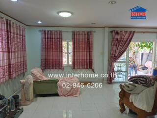 Cozy living room with large windows and pink curtains