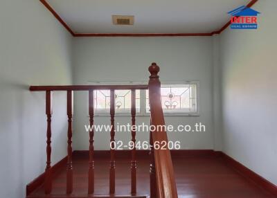 Stairwell with wooden railing and window