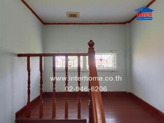 Stairwell with wooden railing and window