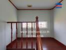 Stairwell with wooden railing and window