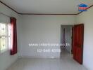 Bedroom with a window, red curtains, and a wooden door