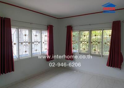 Living room with large windows and red curtains