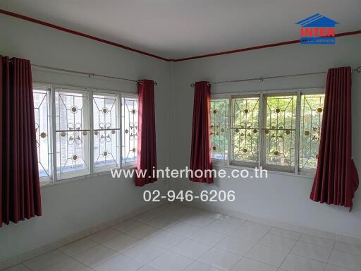 Living room with large windows and red curtains