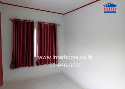 Empty bedroom with white walls and red curtains