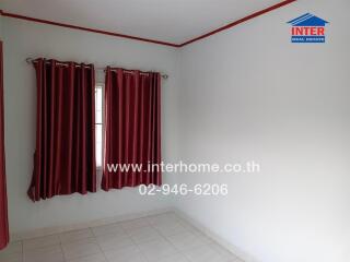 Empty bedroom with white walls and red curtains