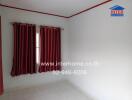 Empty bedroom with white walls and red curtains