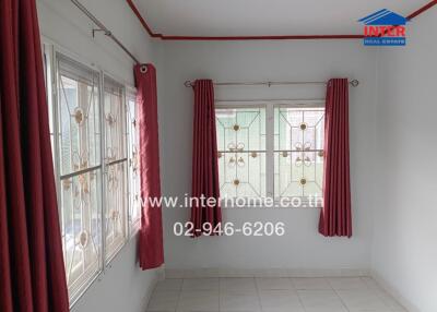 Living room with large windows and red curtains