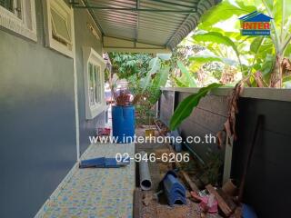 Covered outdoor area with tiled floor and garden