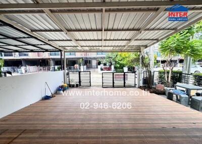 Covered outdoor area with wooden flooring and view of a residential neighborhood